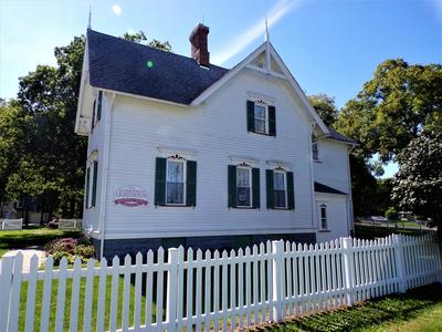 white house with a white picket fence
