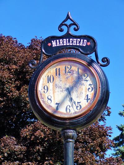 A clock on a pole outside