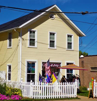 A shop with flags flying in the front